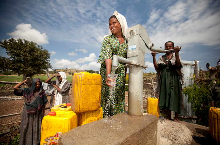 women pouring clean water
